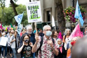 crowd of people with placards and banners on demonstration