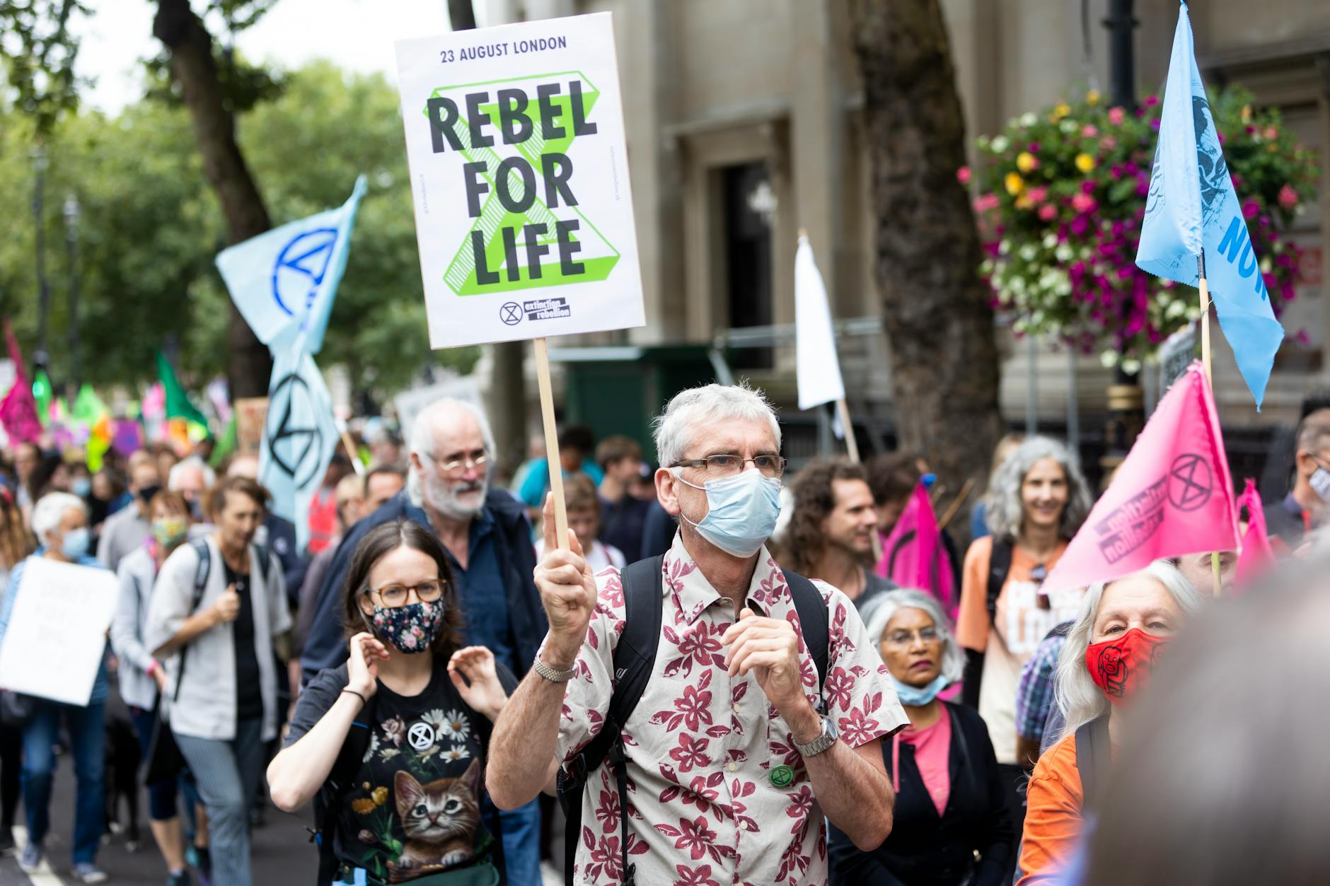 crowd of people with placards and banners on demonstration